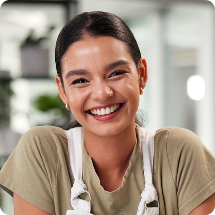 Professional smiling while working in a modern office environment.
